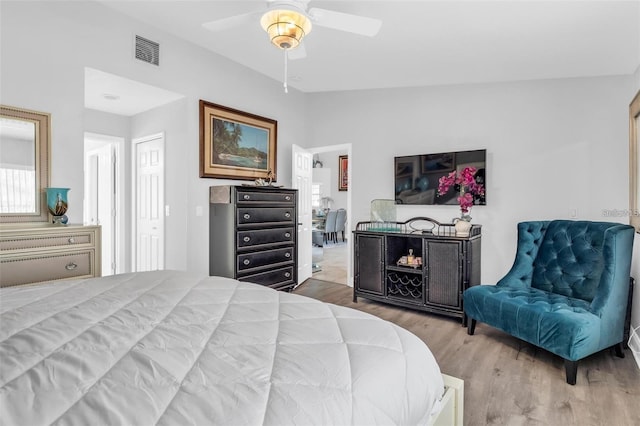 bedroom featuring hardwood / wood-style flooring, ceiling fan, vaulted ceiling, and a closet