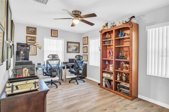 home office featuring ceiling fan and light hardwood / wood-style flooring