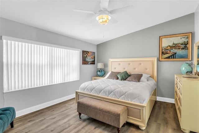 bedroom featuring hardwood / wood-style flooring, ceiling fan, and lofted ceiling