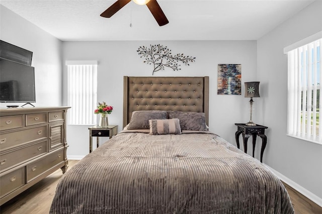 bedroom with light hardwood / wood-style flooring and ceiling fan