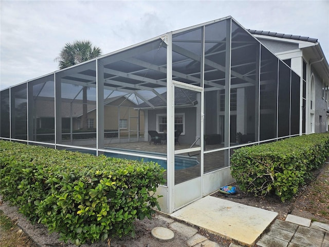 back of property featuring a patio and a lanai