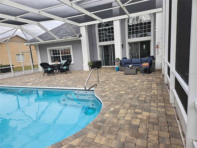 view of pool with a lanai, outdoor lounge area, and a patio area