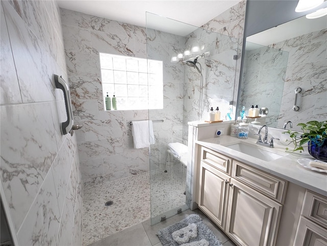 bathroom featuring a marble finish shower and vanity