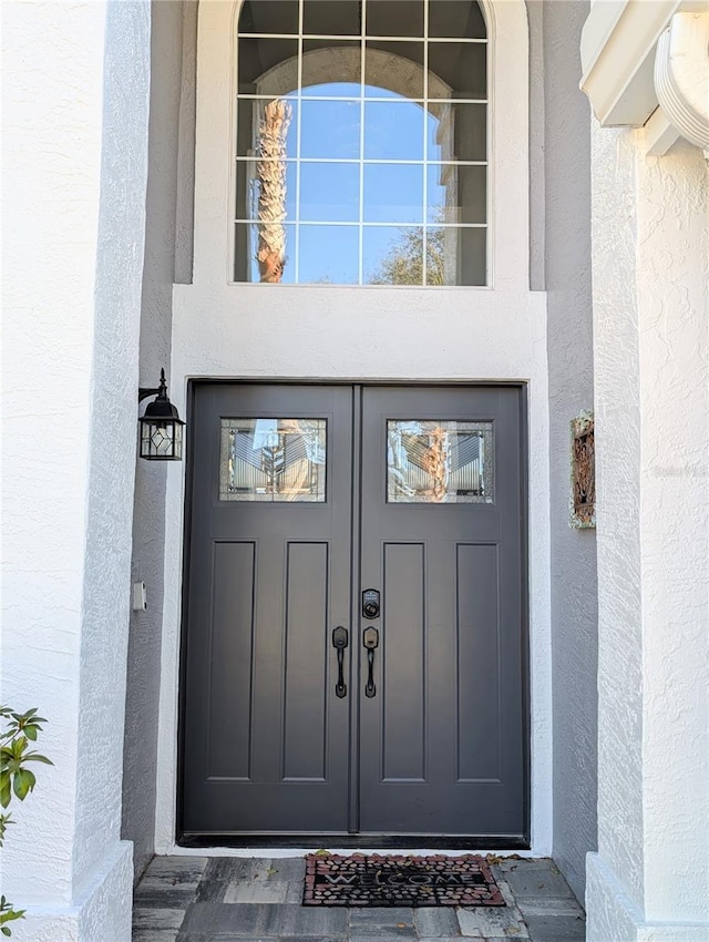 entrance to property with stucco siding