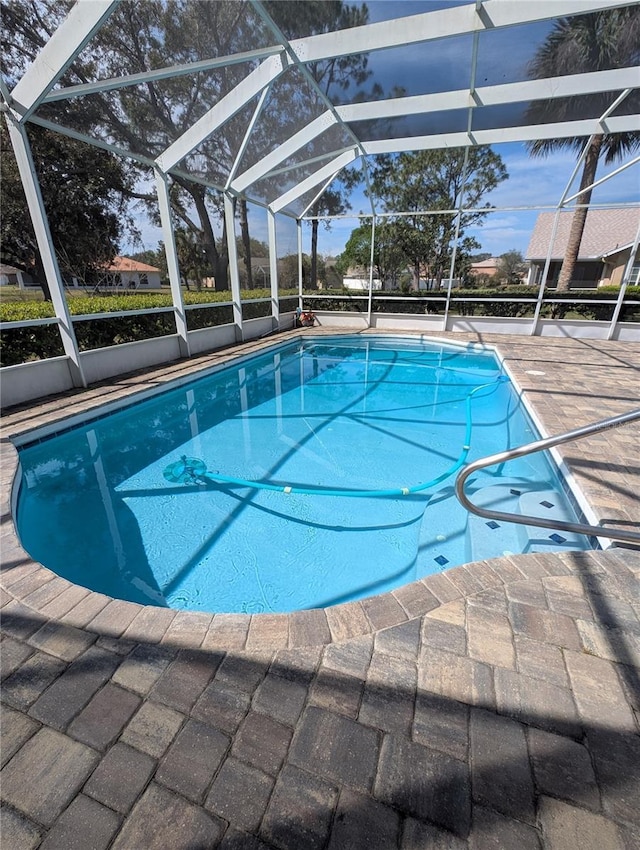 pool featuring a lanai and a patio area