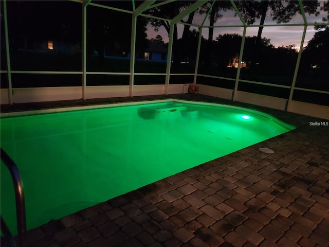 view of swimming pool with a lanai and a patio