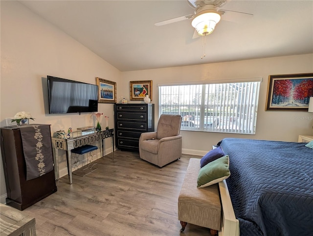 bedroom featuring lofted ceiling, ceiling fan, wood finished floors, and baseboards