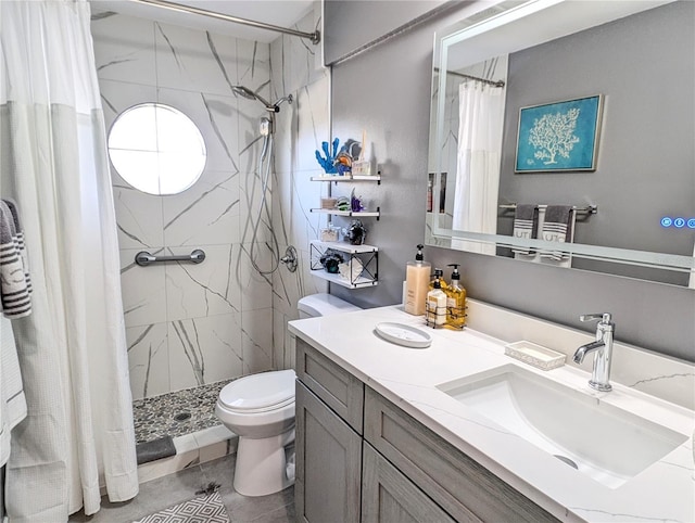 bathroom featuring a shower stall, toilet, and vanity