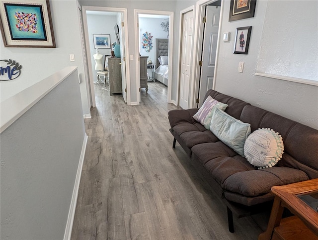 living room featuring baseboards and wood finished floors