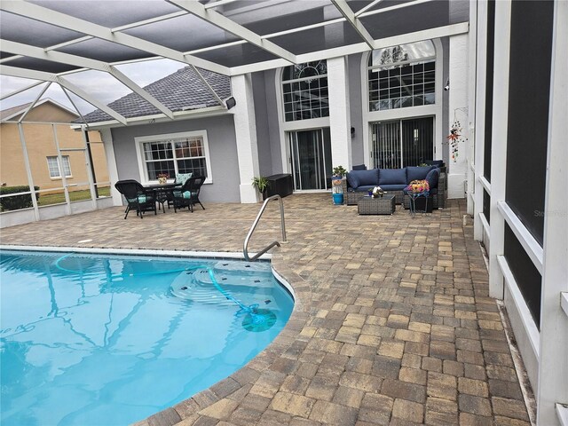 outdoor pool featuring a lanai, outdoor lounge area, a patio, and outdoor dining area