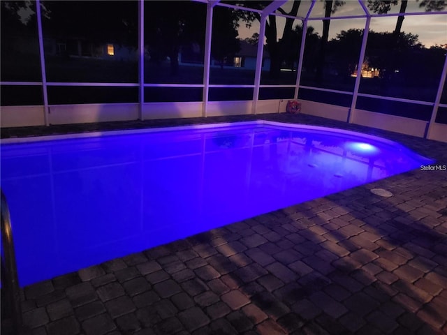 outdoor pool with a lanai and a patio