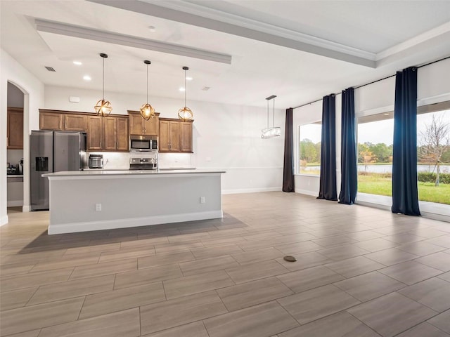 kitchen featuring a center island with sink, recessed lighting, light countertops, appliances with stainless steel finishes, and brown cabinets