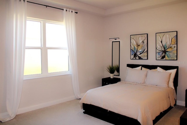 carpeted bedroom featuring baseboards