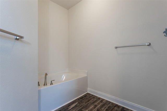 bathroom with hardwood / wood-style floors and a bathing tub