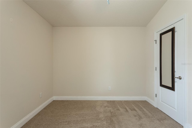 unfurnished room with light colored carpet