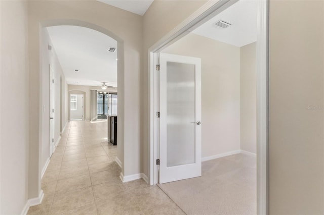 corridor with light tile patterned floors