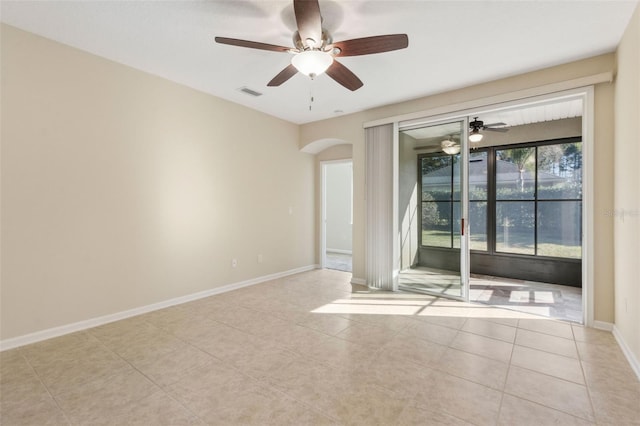 tiled spare room with ceiling fan