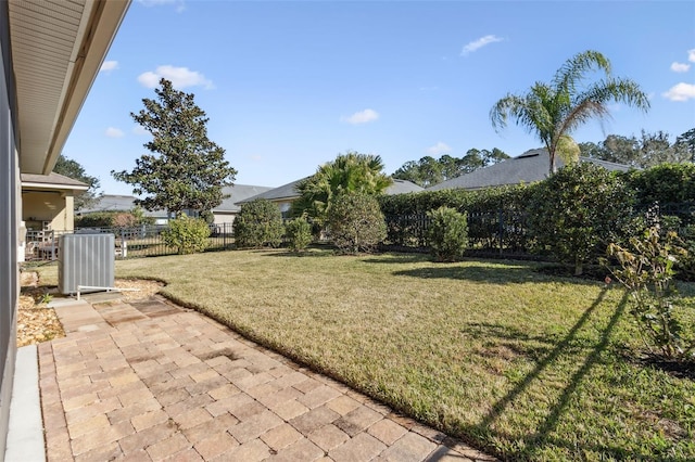 view of yard featuring central AC unit and a patio