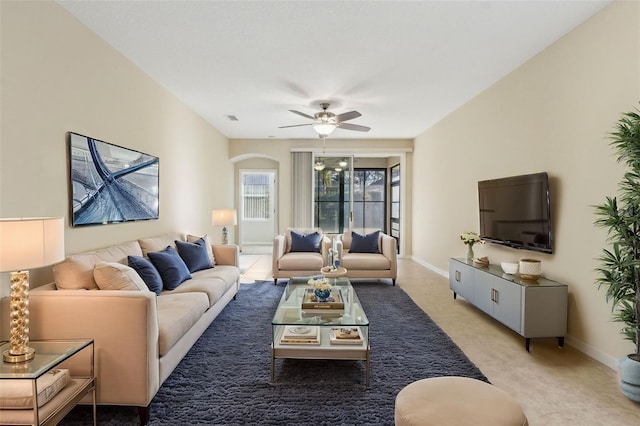 carpeted living room with ceiling fan