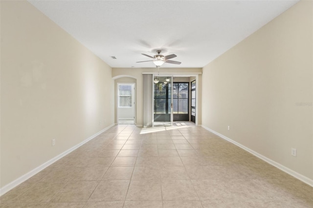 tiled spare room with ceiling fan