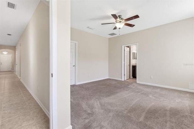 carpeted spare room featuring ceiling fan