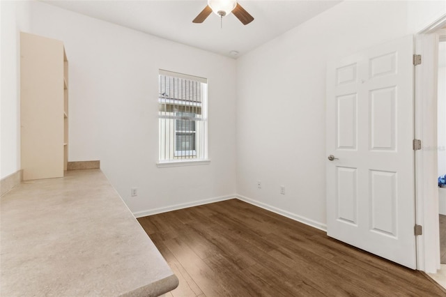 empty room featuring ceiling fan and dark hardwood / wood-style floors