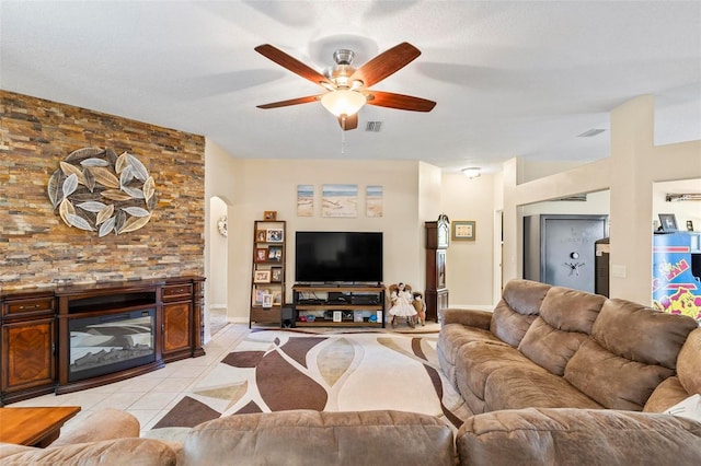 tiled living room featuring ceiling fan