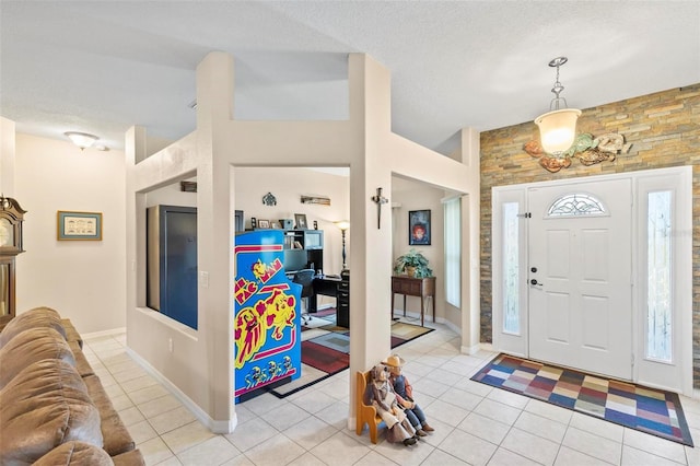 tiled foyer entrance with a textured ceiling