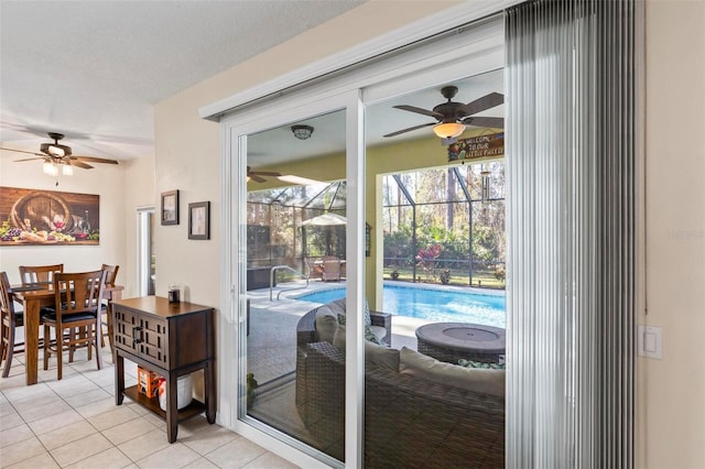 entryway featuring light tile patterned flooring, ceiling fan, and a textured ceiling