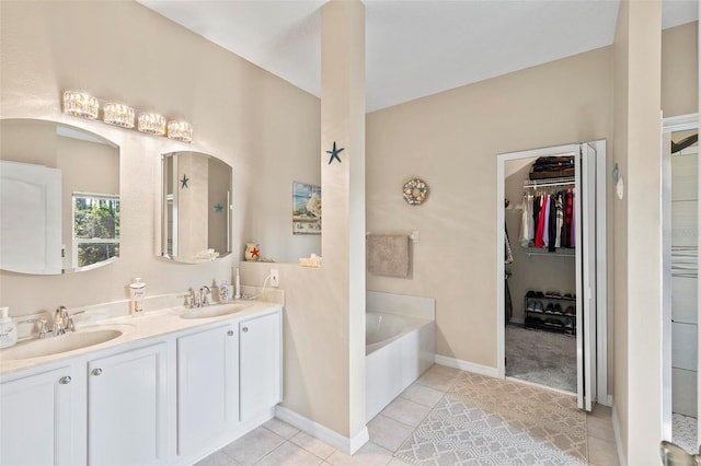 bathroom featuring vanity, a tub, and tile patterned floors