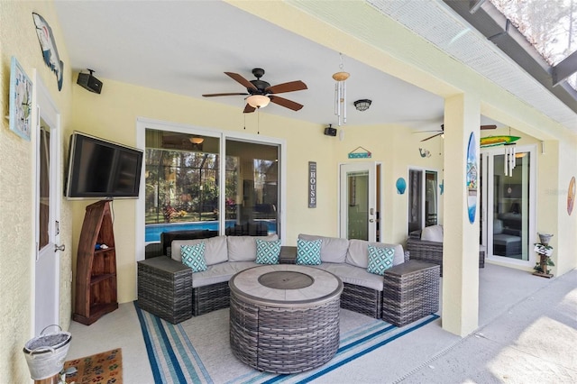 view of patio / terrace with an outdoor living space with a fire pit and french doors