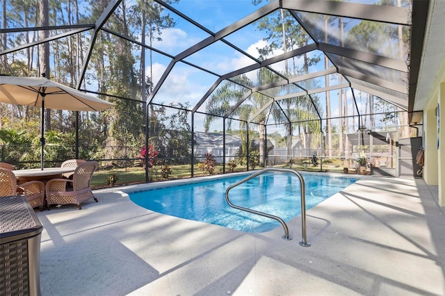 view of swimming pool with a lanai and a patio