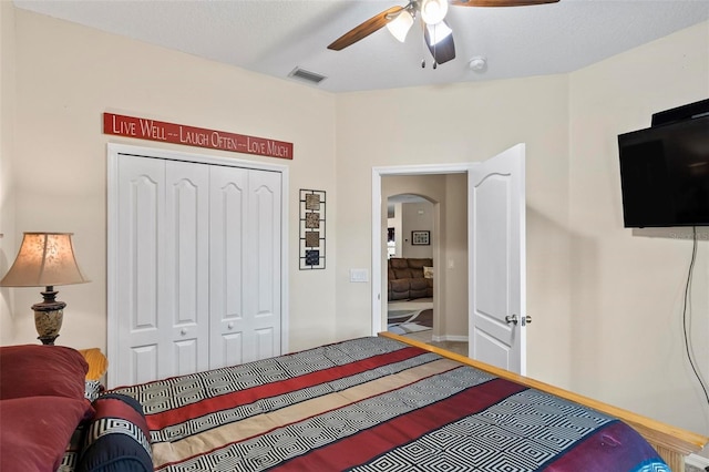 bedroom with ceiling fan and a closet