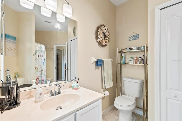 bathroom with vanity, toilet, and tile patterned flooring