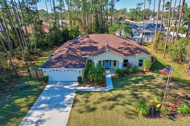 view of front of house featuring a garage and a front lawn