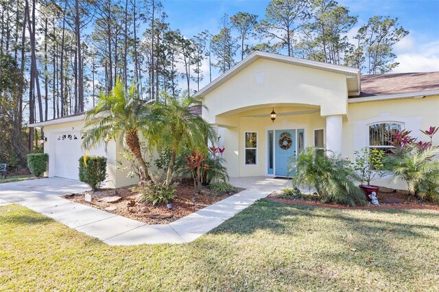 view of front of home with a garage and a front yard