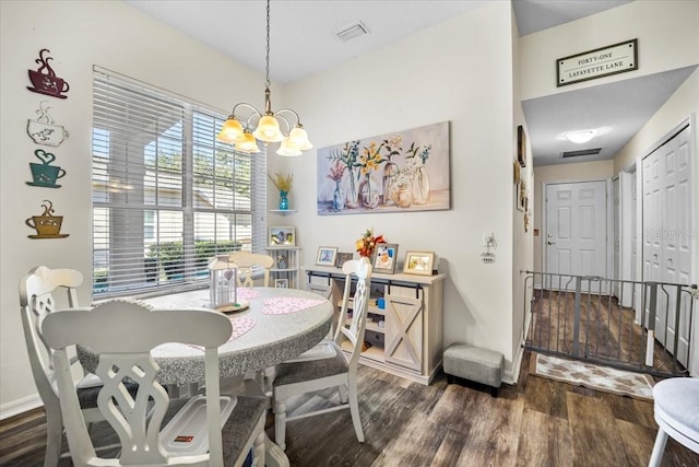 dining space with an inviting chandelier and dark wood-type flooring