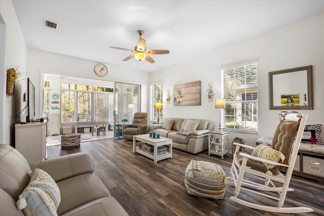 living room with ceiling fan, plenty of natural light, and dark hardwood / wood-style floors