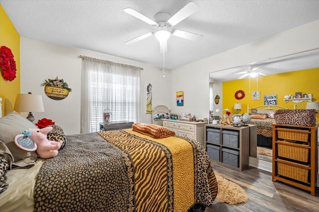 bedroom with wood-type flooring, a textured ceiling, and ceiling fan