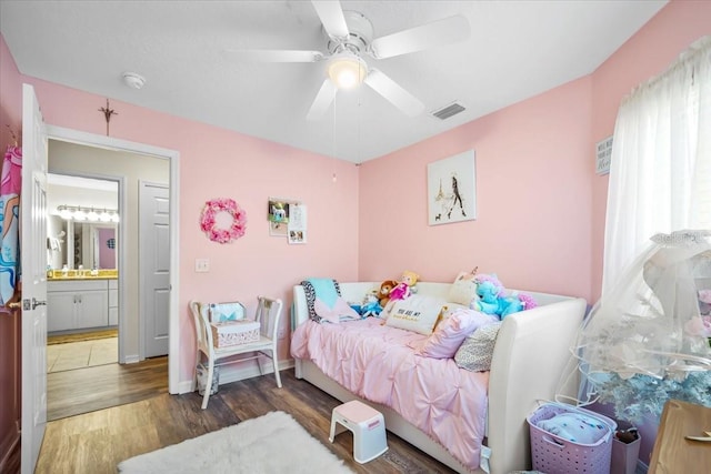 bedroom featuring ceiling fan, dark hardwood / wood-style flooring, and ensuite bathroom