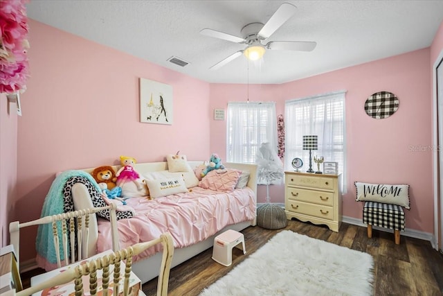 bedroom featuring dark hardwood / wood-style floors and ceiling fan