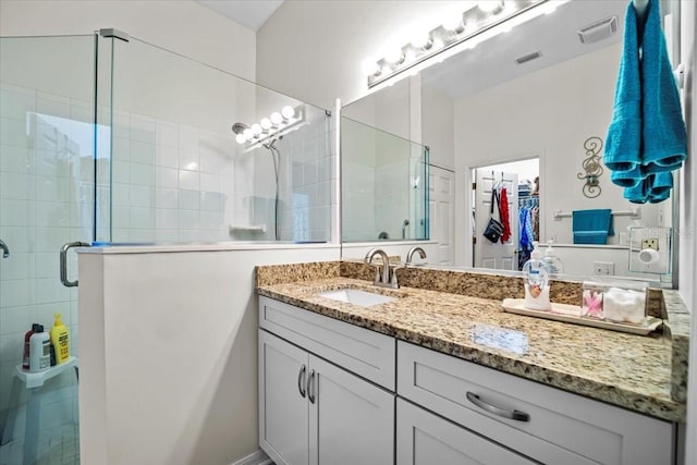 bathroom featuring vanity and an enclosed shower