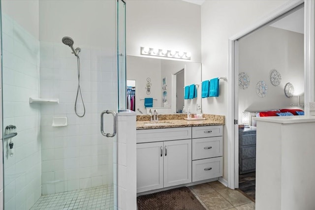 bathroom with vanity and a shower with shower door