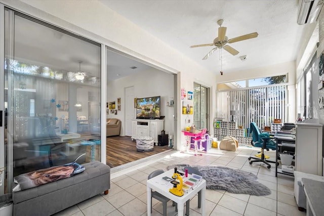 sunroom with a wall mounted air conditioner and ceiling fan