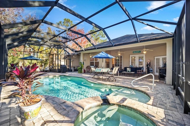 view of swimming pool featuring glass enclosure, french doors, ceiling fan, an in ground hot tub, and a patio