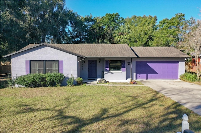 ranch-style house with a garage and a front lawn