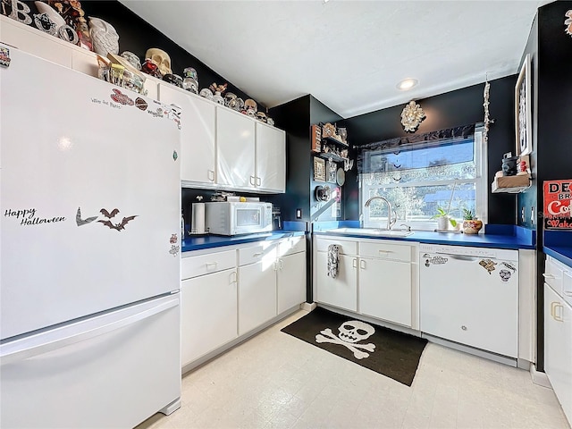 kitchen featuring white cabinetry, white appliances, and sink