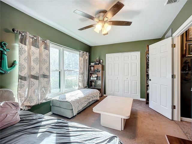 carpeted bedroom with a closet and ceiling fan