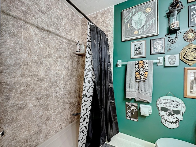 bathroom featuring shower / bathtub combination with curtain and toilet