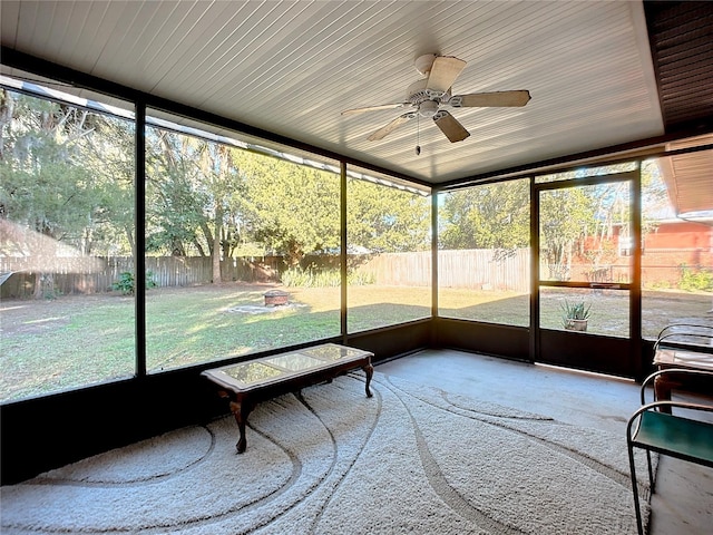 unfurnished sunroom with ceiling fan